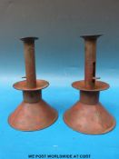 A pair of 19thC sand weighted ejector candle sticks