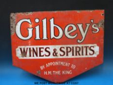 A double sided enamel advertising sign 'Gilbey's Wines and Spirits by appointment to H M The King'