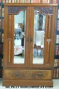 An Art Nouveau wardrobe with bevelled mirrors (W117 x D45 x H190cm)