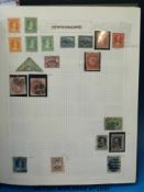 An album of Newfoundland, Ceylon and Hong Kong stamps.