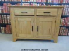 A modern light oak sideboard with two drawers over cabinets (H90 x W120 x D40cm)