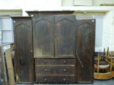 A 19thC Gothic style compactum with central linen press above three drawers,