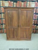 A hardwood cabinet with panelled doors and fitted interior (W120 x D60 x H150cm)