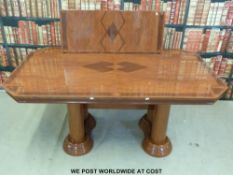 A modern extending dining table with four pillar base and extra leaf together with six dining