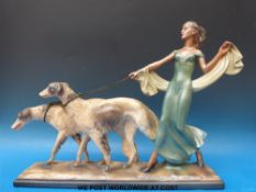 A large Art Deco figure of a lady walking two dogs (height 42cms)