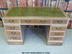 An oak leather inset twin-pedestal desk (W136 x D67 x H78cm)