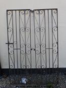 A pair of tall iron scroll work gates complete with hangers (width across pins 116cm,