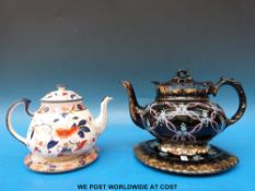 A hand-decorated Victorian teapot on stand and a further transfer-printed example in the 