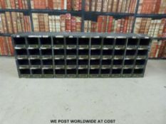 A wooden set of vintage parts drawers or pigeon holes,