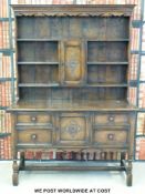 An oak dresser with plate rack above (W124 x D47 x H174cm)