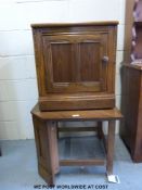 An Ercol corner unit together with a matching cupboard