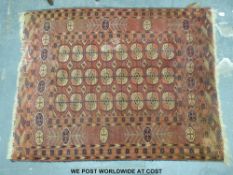 A Bokhara rug with elephant's foot design on red ground and fringed ends (137 x 180cm)