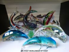 A collection of glass and ceramic fish