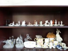 A collection of ring trays together with a model of a girl titled 