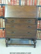 An oak bureau with three drawers below (W74 x D41 x H100cm)