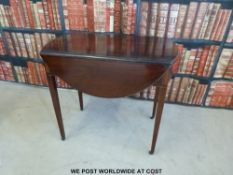 A Georgian inlaid mahogany drop leaf table with dummy drawers to ends,