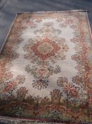 A pure wool 'Arakstan' rug on cream ground with floral border and centre (270 x 360cm)