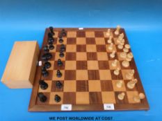 A carved wooden chess set and board, height of king 8.