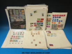 A large quantity of Commonwealth stamps on loose album pages