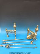 A pair of brass fire dogs together with brass shovel,