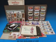 A box containing various cigarette cards mostly in albums including ships, animals, birds, flowers,