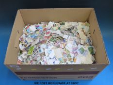 Three boxes of loose GB Commonwealth and foreign stamps in cartons and packets and sundry