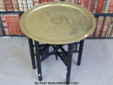 A Berber brass table with folding legs circa 1900.