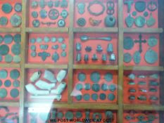 Display case of curios in glazed sectional oak display case, includes vintage keys, whistles, coins,