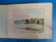 A leather bound autograph album with various watercolours and sketches.