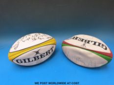 Two signed rugby balls.