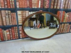 An oval mirror with bevelled glass (maximum diameter 90cm)
