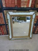 A bevelled glass cushion mirror with gilt surround (overall 65 x 55cm)
