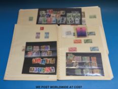 A folder of Italian stamps on loose album pages,