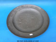 A large 19thC pewter charger initialled GTM (diameter 49cm)