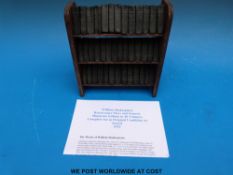 A miniature edition, 40 volumes of Shakespeare's plays and sonnets in bookcase.