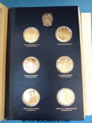 A set of limited edition 648/1000 silver gilt Churchill centenary medals in book by John Pinches