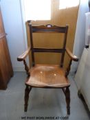 A 19thC elm-seated armchair or captain's chair