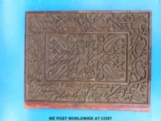 A carved blotter or book cover
