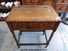 A carved oak table with lift up flap (W61 x D38 x H76cm)