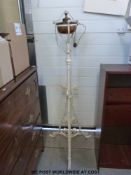 A wrought iron and copper extending standard lamp