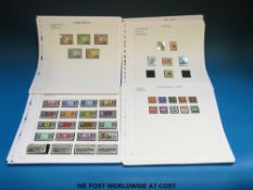 A selection of Commonwealth QEII stamps on loose album sheets