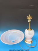 A large table lamp with glass base and shade