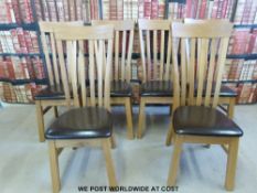 A set of six light oak dining chairs with upholstered seats