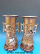 A pair of Japanese Satsuma vases decorated with immortals on hardwood stands (23.