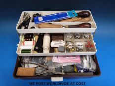 A tool box containing a quantity of leatherwork tools
