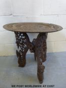 An Indonesian carved side table featuring dragon legs and dancers to centre of top