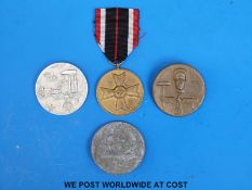 Three 1930's Nazi German rally badges or 'tinnies' together with a 1939 Merit medal
