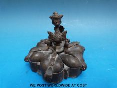 A small Indian bronze dish with six heart shaped lidded compartments,