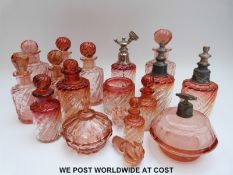 A set of eight graduated wrythen moulded amberina glass scent bottles,