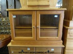 A pine television cupboard with glass doors (W85 x D50 x H59cm)